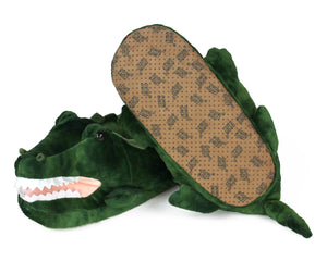 Pair of plush alligator slippers, showing the bottom of one slipper with non-slip grips on soles